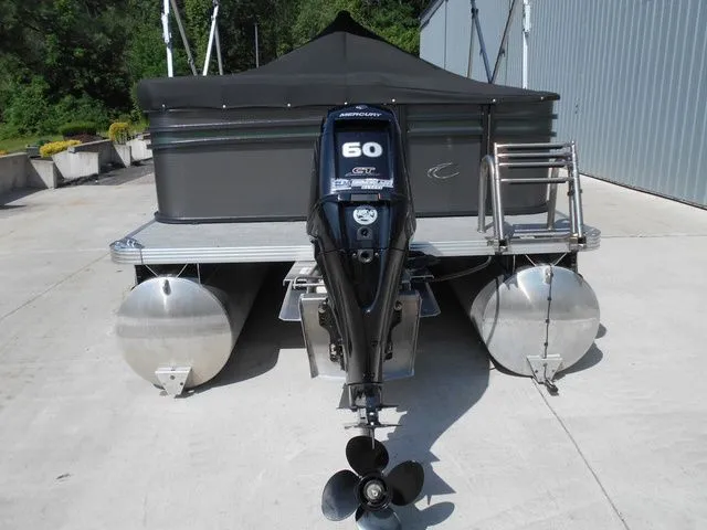 Slide: The Image of A 2024 Crest Classic LX 200 L pontoon boat with a Mercury 60 HP outboard motor. - 3