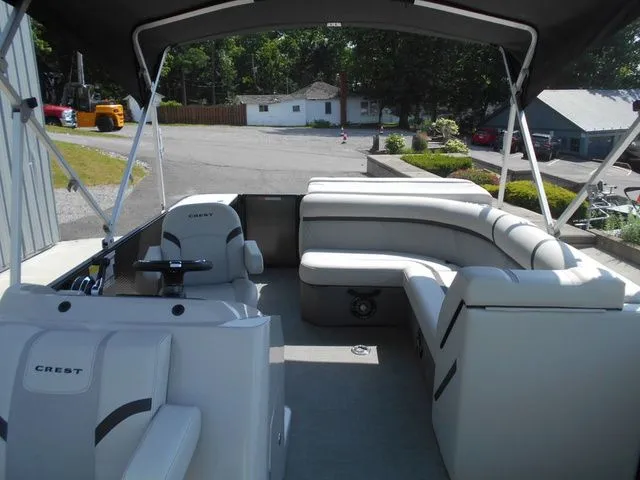 Slide: The Image of Interior view of a Crest Classic LX 200 L pontoon boat with gray seating and black canopy. - 9