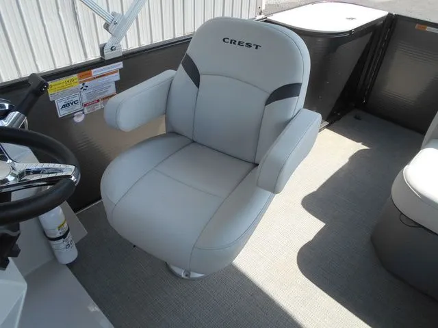 Slide: The Image of A comfortable, padded seat on a boat with the Crest logo on the backrest. - 13