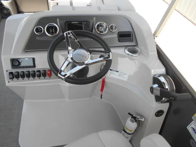Slide: The Image of The image shows the helm of a 2024 Crest Classic LX 200 L boat with modern instruments. - 14