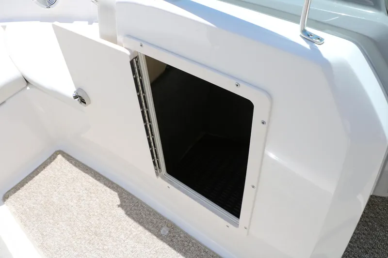 Slide: The Image of Open storage compartment on 2013 Chaparral 19 Sport H2O boat interior. - 31