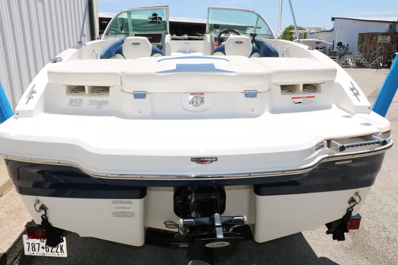 Slide: The Image of 2013 Chaparral 19 Sport H2O boat, rear view, showcasing seating and engine area. - 36