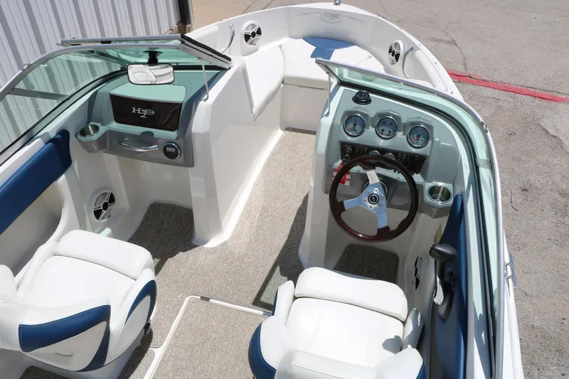 Slide: The Image of 2013 Chaparral 19 Sport H2O boat interior with steering wheel and seating. - 10