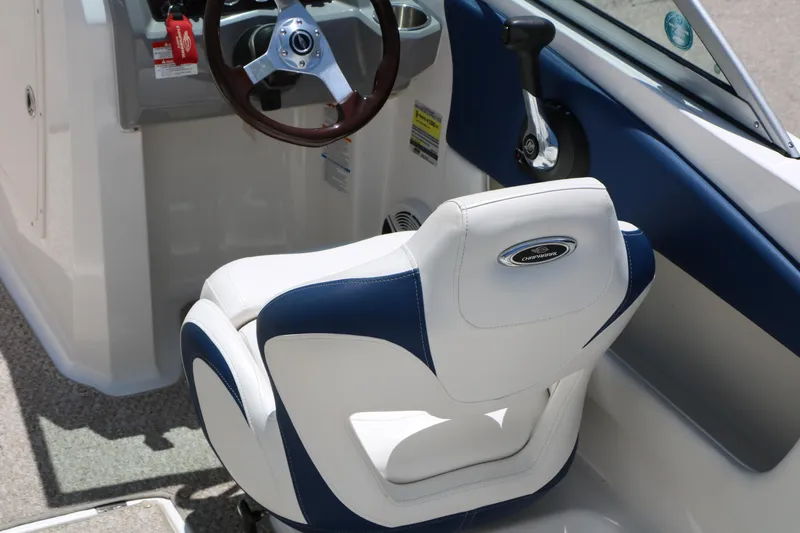 Slide: The Image of 2013 Chaparral 19 Sport H2O boat interior with steering wheel and seat detail. - 9