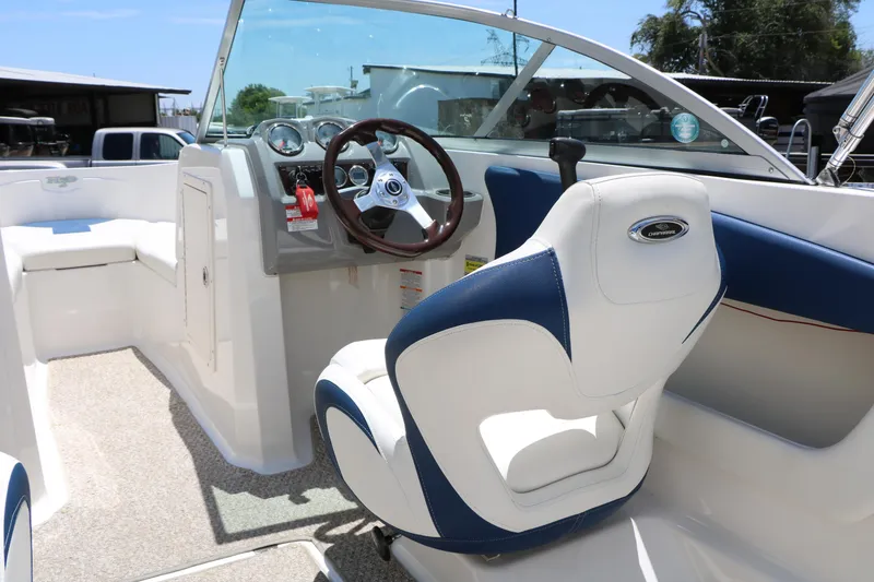 Slide: The Image of 2013 Chaparral 19 Sport H2O boat interior with steering wheel and seating. - 17