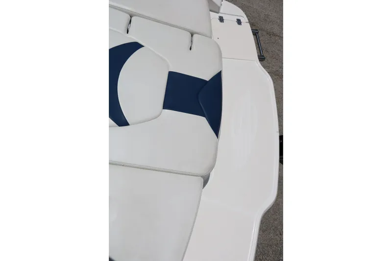 Slide: The Image of 2013 Chaparral 19 Sport H2O boat interior with white and blue seating. - 32
