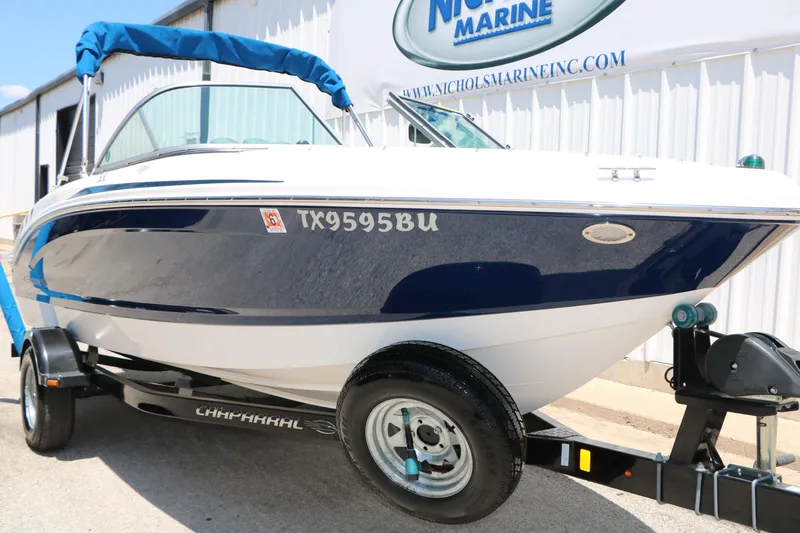 Slide: The Image of 2013 Chaparral 19 Sport H2O boat on trailer, blue and white exterior. - 3