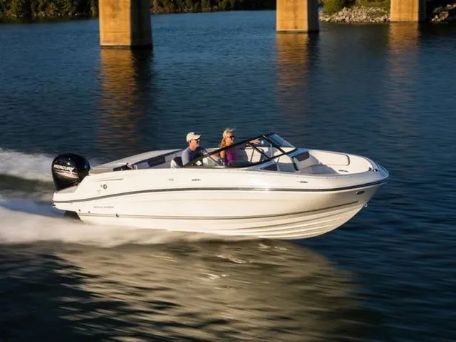 The Image of A 2019 Bayliner VR5 Bowrider OB cruising on calm water under a bridge. - 1