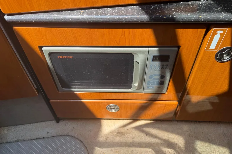 Slide: The Image of Built-in microwave in 2006 Formula 330 Sun Sport boat kitchen area. - 23