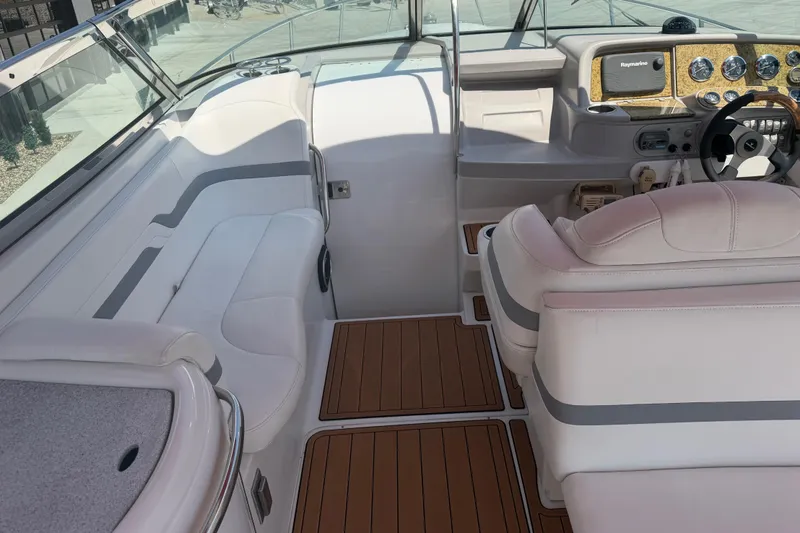 Slide: The Image of Interior of a 2006 Formula 330 Sun Sport boat with white seating and wood accents. - 12