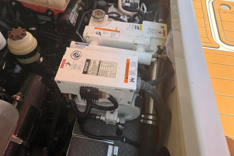 Slide: The Image of Engine compartment of a 2006 Formula 330 Sun Sport boat, featuring Kohler generator components. - 25