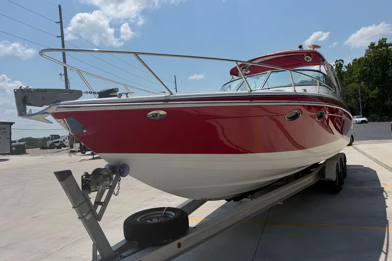 Slide: The Image of 2006 Formula 330 Sun Sport boat on trailer under clear sky. - 9