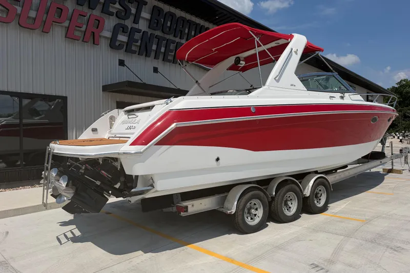 Slide: The Image of 2006 Formula 330 Sun Sport boat on trailer at dealership, red and white design. - 3