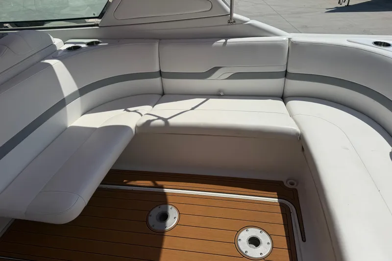 Slide: The Image of 2006 Formula 330 Sun Sport boat interior with white seating and wooden flooring. - 13