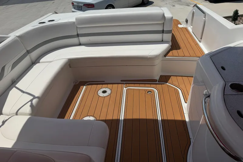 Slide: The Image of 2006 Formula 330 Sun Sport boat interior with white seating and teak flooring. - 11