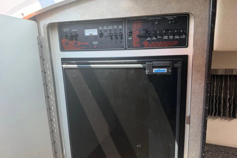 Slide: The Image of Control panel and refrigerator inside a 2006 Formula 330 Sun Sport boat. - 21