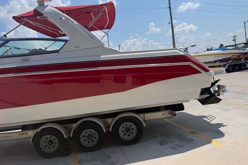 Slide: The Image of 2006 Formula 330 Sun Sport boat on trailer, red and white design, parked outdoors. - 7