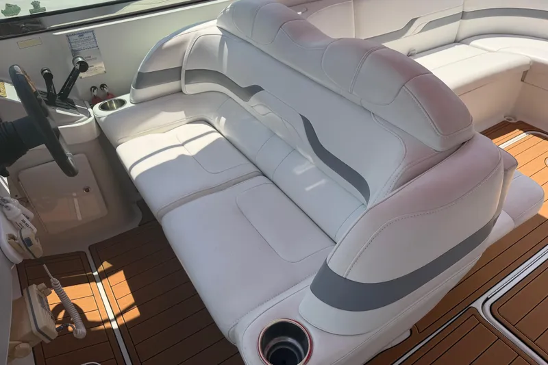 Slide: The Image of 2006 Formula 330 Sun Sport boat interior with white seating and wood flooring. - 14