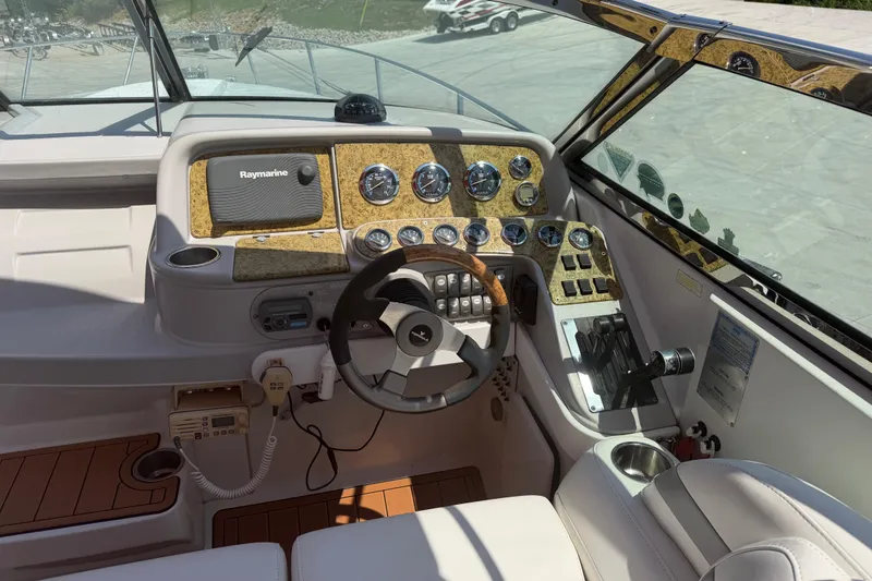 Slide: The Image of Cockpit of 2006 Formula 330 Sun Sport with Raymarine navigation and wood-accented dashboard. - 15