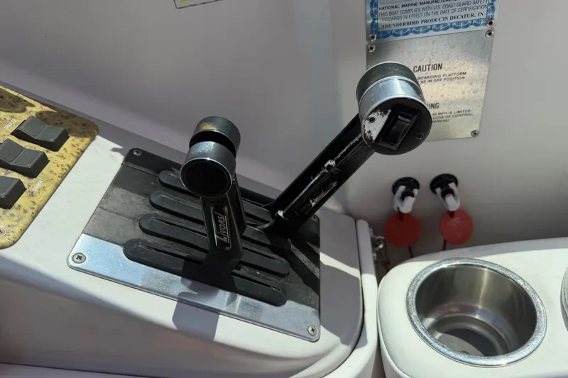 Slide: The Image of Throttle controls on a 2006 Formula 330 Sun Sport boat dashboard. - 17