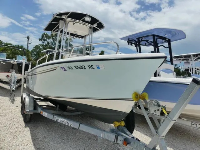 The Image of A 2010 May-Craft 1900 boat on a trailer in a gravel lot. - 1
