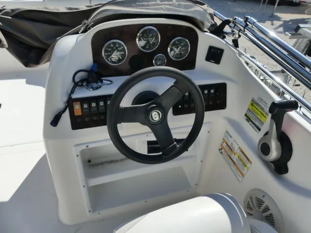 Slide: The Image of The image shows the helm of a 2012 Hurricane Sundeck 188 boat. - 7
