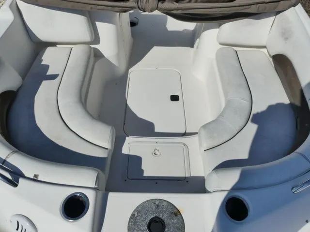 Slide: The Image of Interior view of a 2012 Hurricane Sundeck 188 boat with white cushioned seating. - 12
