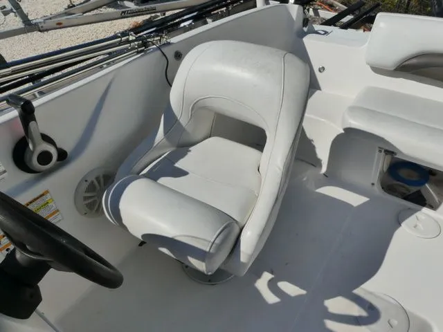 Slide: The Image of A white seat in a boat with a steering wheel and control console. - 9