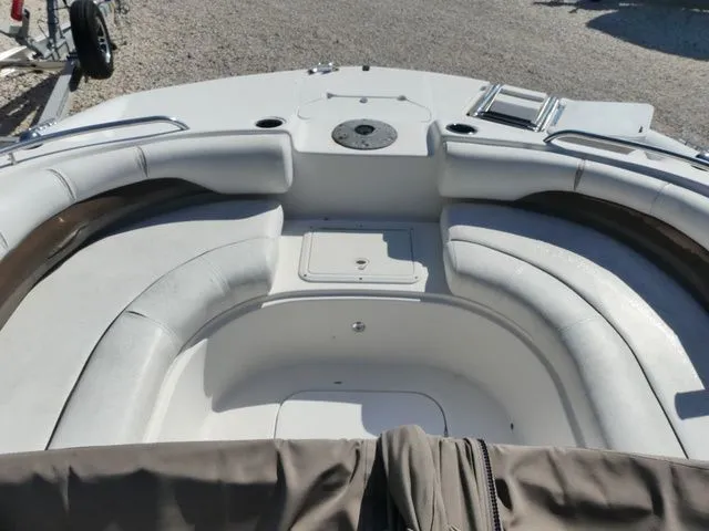 Slide: The Image of The image shows the cockpit of a 2012 Hurricane Sundeck 188 boat with cushioned seating. - 10