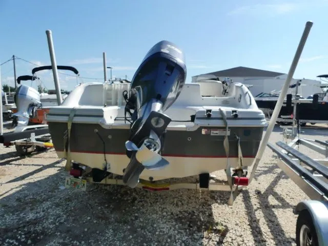 Slide: The Image of The image shows a 2012 Hurricane Sundeck 188 boat on a trailer. - 4