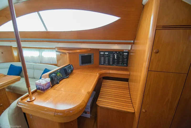 Slide: The Image of Interior of a 2006 Jeanneau Sun Odyssey 54 DS with wooden furnishings and navigation equipment. - 27