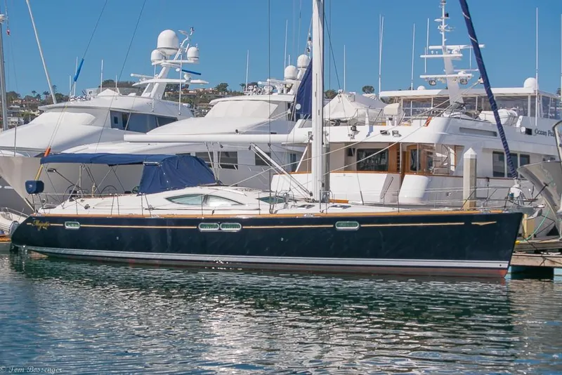 The Image of A 2006 Jeanneau Sun Odyssey 54 DS docked in a marina, surrounded by other yachts. - 0
