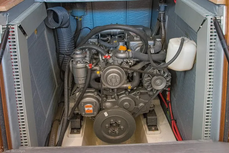 Slide: The Image of Engine compartment of a 2006 Jeanneau Sun Odyssey 54 DS with visible engine and hoses. - 39