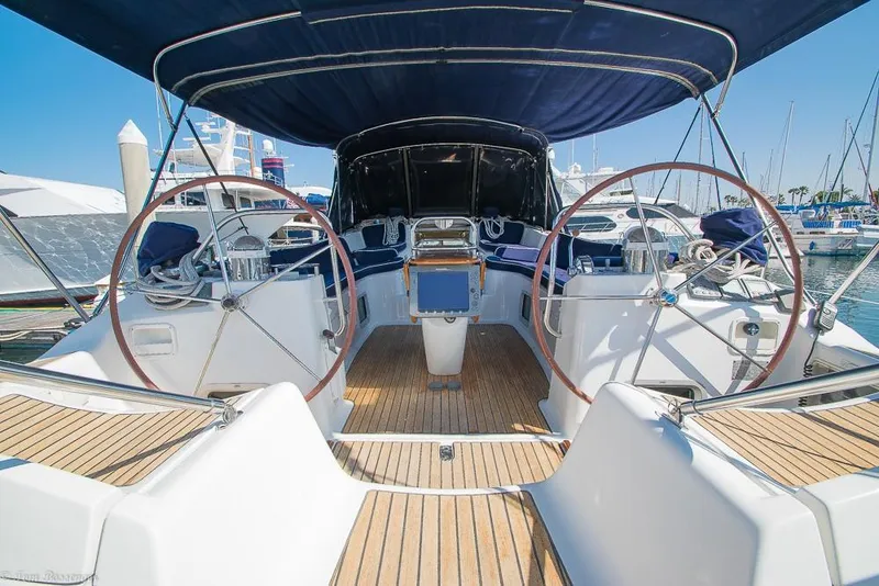 Slide: The Image of The image shows the cockpit of a 2006 Jeanneau Sun Odyssey 54 DS with dual steering wheels and teak decking. - 40
