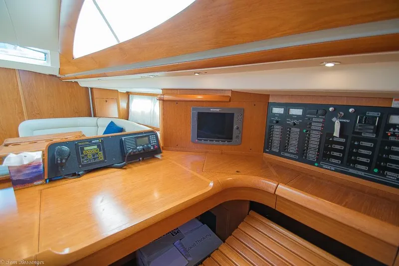 Slide: The Image of Interior view of a sailboat with wooden table, navigation system, and control panel. - 31