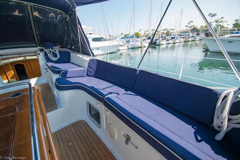 Slide: The Image of The image shows the cockpit of a 2006 Jeanneau Sun Odyssey 54 DS with blue cushions. - 47