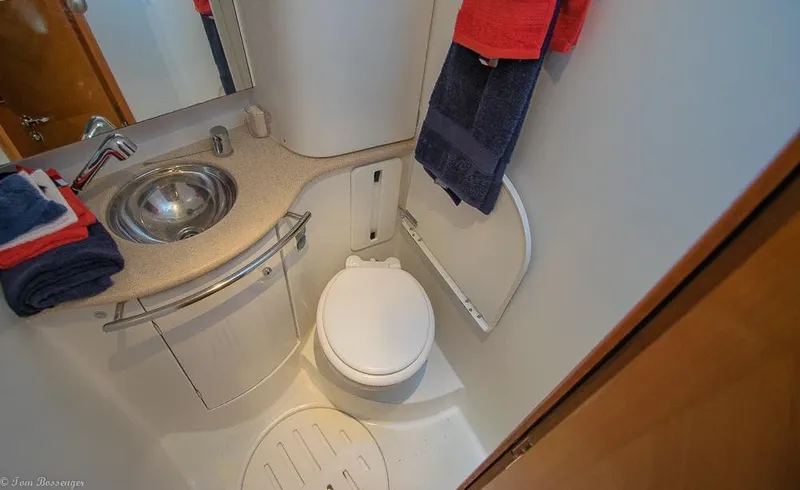 Slide: The Image of Compact bathroom with sink, toilet, and towels on a Jeanneau Sun Odyssey 54 DS sailboat. - 34