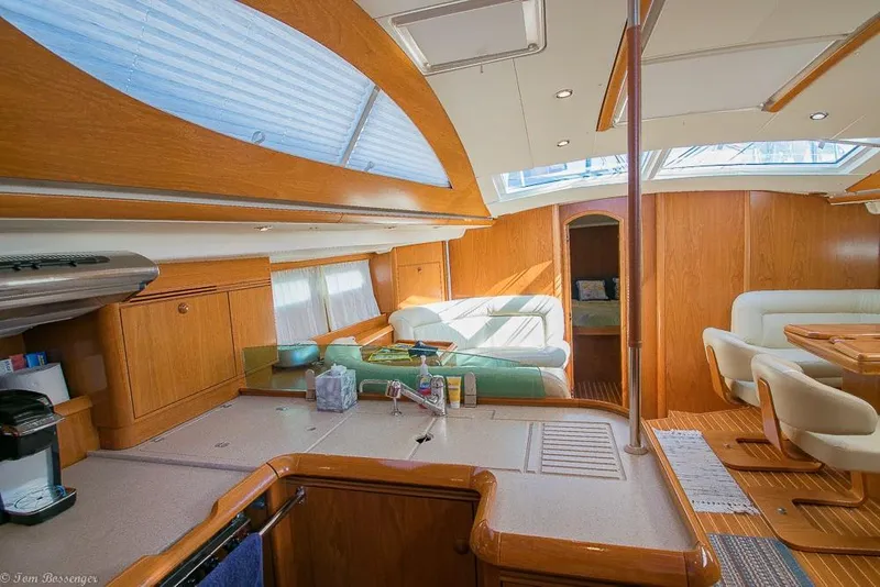 Slide: The Image of Interior of a 2006 Jeanneau Sun Odyssey 54 DS with light wood finishes and large windows. - 4