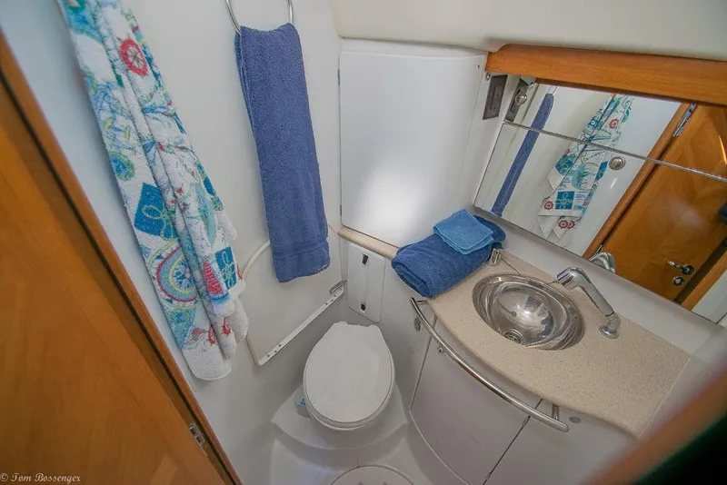 Slide: The Image of The image shows a boat bathroom with a sink, toilet, and towels. - 37