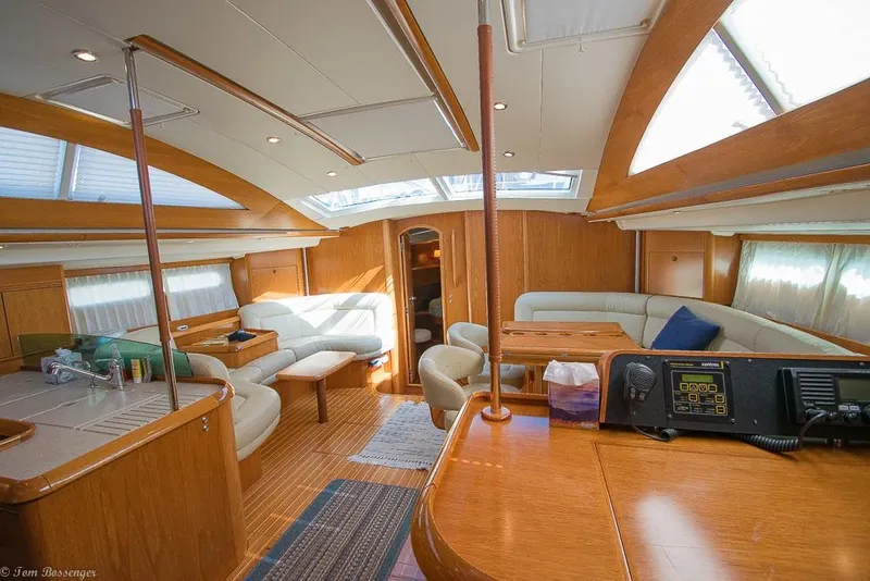Slide: The Image of The image shows the interior of a 2006 Jeanneau Sun Odyssey 54 DS with elegant wood finishes. - 2