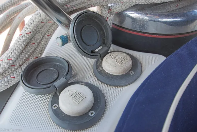 Slide: The Image of Close-up of two round covers on a sailboat, surrounded by ropes. - 49