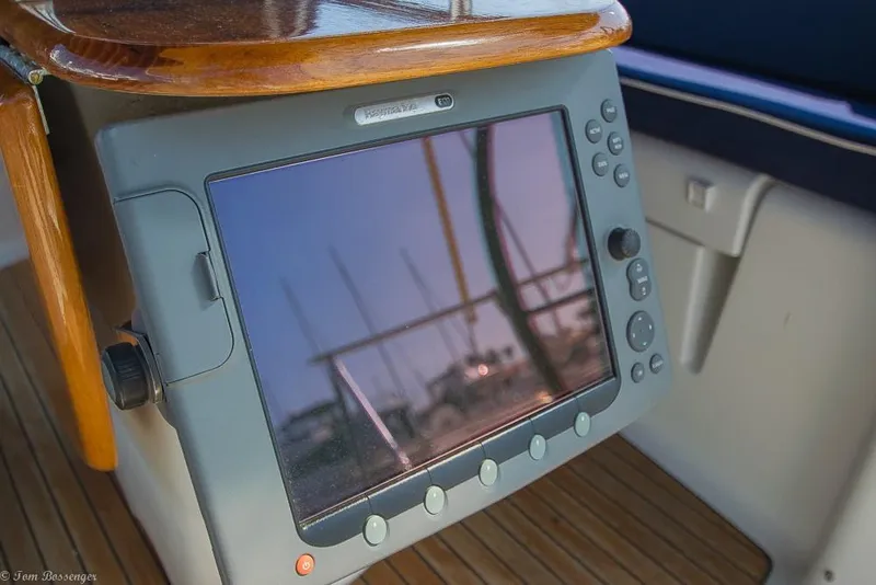 Slide: The Image of A navigation system on a 2006 Jeanneau Sun Odyssey 54 DS, featuring wood details and deck flooring. - 43
