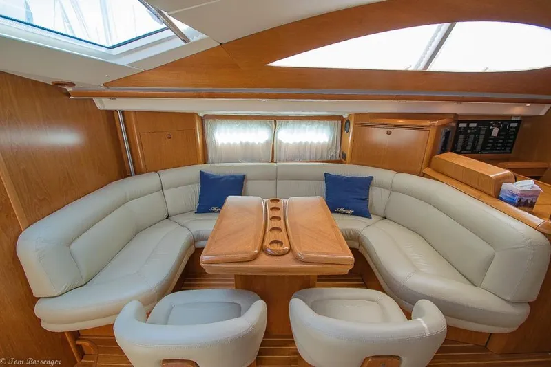 Slide: The Image of The interior of the 2006 Jeanneau Sun Odyssey 54 DS features an elegant seating area with cream upholstery. - 6