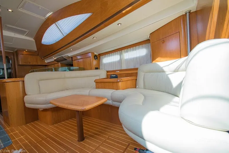 Slide: The Image of Interior of a 2006 Jeanneau Sun Odyssey 54 DS with elegant wood paneling and comfortable seating. - 11