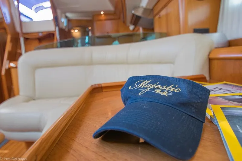 Slide: The Image of Interior of a 2006 Jeanneau Sun Odyssey 54 DS with a blue hat on a table. - 12