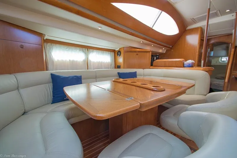 Slide: The Image of Interior of a 2006 Jeanneau Sun Odyssey 54 DS with elegant seating area and wooden table. - 9