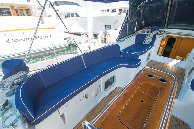 Slide: The Image of The image shows the cockpit of a 2006 Jeanneau Sun Odyssey 54 DS with blue cushions. - 48