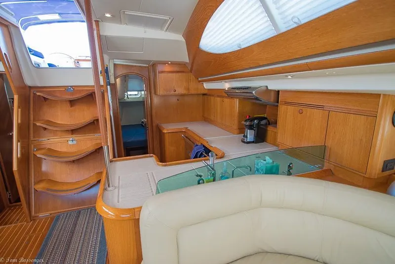 Slide: The Image of Interior of a 2006 Jeanneau Sun Odyssey 54 DS with elegant wood finish and cozy seating area. - 25