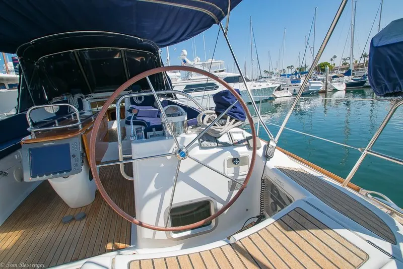 Slide: The Image of The image shows the cockpit of a 2006 Jeanneau Sun Odyssey 54 DS in a marina. - 41