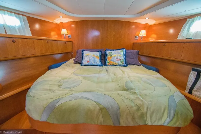 Slide: The Image of The cabin of the 2006 Jeanneau Sun Odyssey 54 DS features a cozy double bed with decorative pillows. - 19